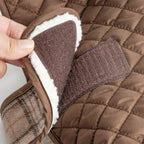 Close up of brown quilted dog jacket with fleece lining and velcro strap closure
