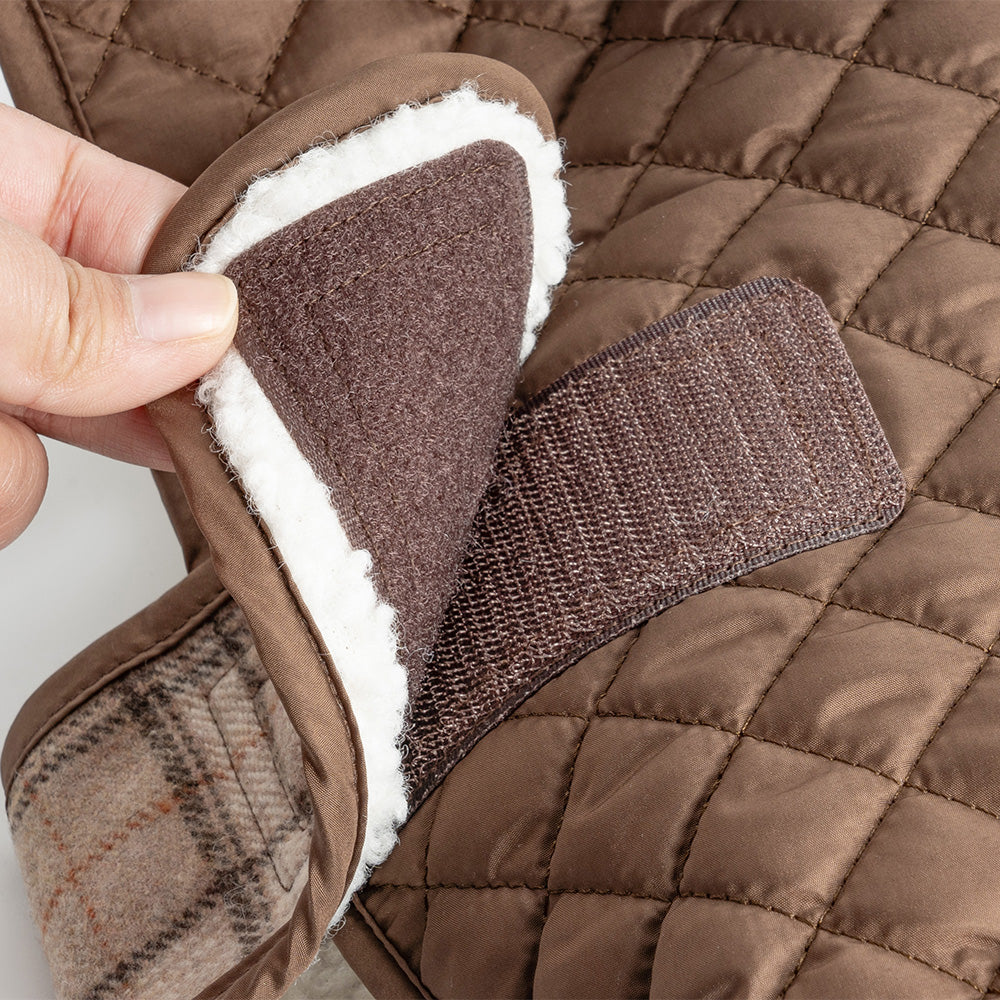 Close up of brown quilted dog jacket with fleece lining and velcro strap closure
